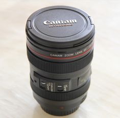 a camera lens sitting on top of a wooden table