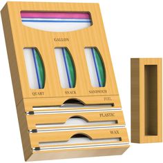 a wooden box with four different types of toothbrushes in it next to a cardboard holder