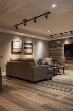 a living room filled with furniture and a flat screen tv mounted on the wall above it