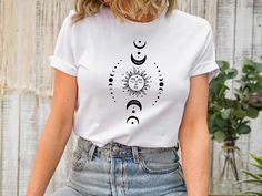 Mystic Moon And Sun T-shirt, Mystical Moon Phase T-shirt, Moon Phase T-Shirt, Vintage Moon T-shirt ,Boho Moon T-shirt,Celestial Moon T-shirt ❀DETAIL❀ For printing, we use Bella Canvas and Gildan SoftStyle brand shirts, which are the best in the industry. *Bella Canvas -unisex size -4.2 oz. -Solid colors are 100% Combed Cotton and Ring-Spun Cotton. -Athletic Heather 90% Combed and Ring-Spun Cotton, 10% Polyester -All Heather CVC Colors 52% Combed and Ring-Spun, 48% Polyester *Gildan SoftStyle -un White Moon Print T-shirt For Summer, Casual Summer T-shirt With Sun And Moon Design, Bohemian Summer Tops With Moon Print, Summer Crew Neck T-shirt With Sun And Moon Design, Bohemian Short Sleeve T-shirt With Sun And Moon Design, Bohemian Cotton T-shirt With Sun And Moon Design, Festival Graphic Tee With Moon Print, Bohemian Short Sleeve T-shirt With Moon Print, Moon Tshirt