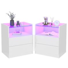 two white nightstands with purple lighting on each side and flowers in vases at the top