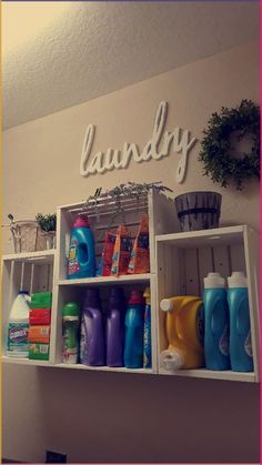 a shelf filled with lots of cleaning supplies next to a sign that says laundry on it