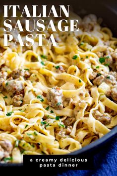 a skillet filled with pasta, meat and cheese on top of a blue towel