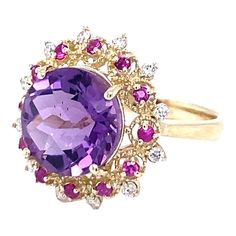 Amethyst, Pink Sapphire, and Diamond Cocktail Ring!  Playful yet Powerful! Its like having a piece of glittery candy on your finger! This ring has a Checkers Round Cut Amethyst that weighs 4.90 Carats and is embellished with alternating 12 Pink Sapphires that weigh 0.28 Carats and 12 Round Cut Diamonds that weigh 0.20 Carats. (Clarity: SI2, Color:F) The total carat weight of the ring is 5.38 Carats.  The ring is crafted in 14 Karat Yellow Gold and weighs approximately 4.8 grams. The ring is a si Amethyst Cocktail Ring, Yellow Gold Cocktail Ring, Feminine Jewelry, Beautiful Gemstones, Diamond Cocktail Ring, Gold Cocktail Ring, Gold Cocktail, Diamond Cocktail Rings, Crown Jewels