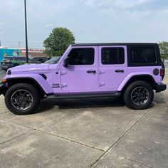 a purple jeep parked in a parking lot