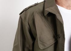 "You are viewing a vintage 80s military parka coat / long jacket in green. Made of thick cotton canvas fabric. Four front pockets. Great classic fit with very masculine vibe. Practical and good looking coat with a button and zip up fastening. Condition: very good vintage. Model measurements: 6 ft (180 cm), he wears size available SIZE Suggested size: M. To be sure it would fit please follow measurements bellow. FLAT Measurements: Length from shoulders: 29\" / 73.5 m Armpit to armpit: 21\" / 53.5 Vintage Green Parka For Outdoor, Vintage Green Parka For Streetwear, Vintage Green Long Sleeve Parka, Vintage Green Utility Jacket For Streetwear, Oversized Vintage Utility Jacket For Winter, Vintage Winter Outerwear With Cargo Pockets, Vintage Outerwear With Cargo Pockets For Winter, Vintage Outerwear With Cargo Pockets For Streetwear, Vintage Fall Parka With Pockets