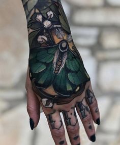 a woman's hand with tattoos on it