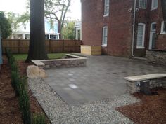 a brick patio in front of a house