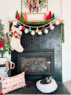 a fireplace decorated for christmas with stockings and stocking hanging from the mantel above it