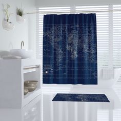 a bathroom with a blue shower curtain and white sink