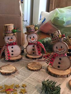 snowmen made out of wood sitting on top of a table