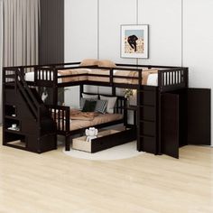 a bunk bed with stairs is in the middle of a wooden flooring area, and there are pictures on the wall above it