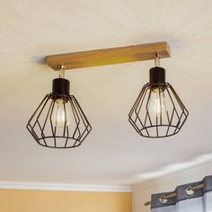 two light fixtures hanging from the ceiling in a kitchen