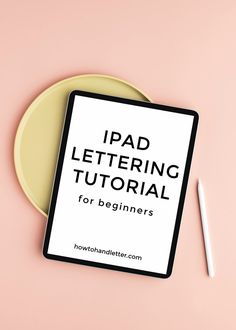 an ipad sitting on top of a yellow plate next to a white pen and paper