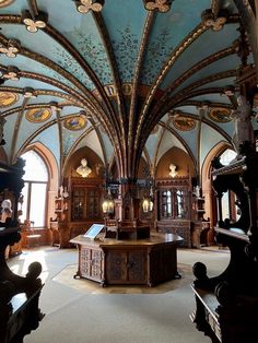 the inside of a large building with many windows and decorations on it's ceiling