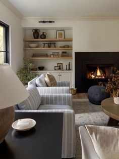 a living room filled with furniture and a fire place