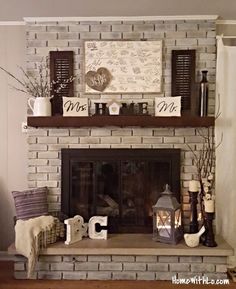 a living room with a brick fireplace and shelves on the mantle, along with decorative items