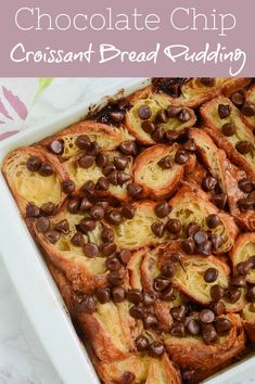 a casserole dish filled with chocolate chips and croissants on top