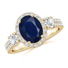 an oval shaped blue sapphire and diamond ring with three smaller round diamonds around the band