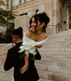 a bride carrying her groom down the stairs