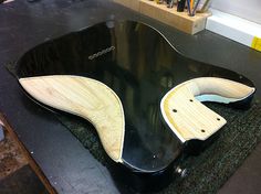 an electric guitar being worked on in a shop