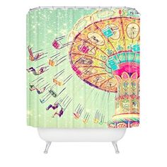 a shower curtain with an image of a carnival ride in the sky and people riding on it