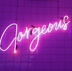 a neon sign that says gorgeous on the wall