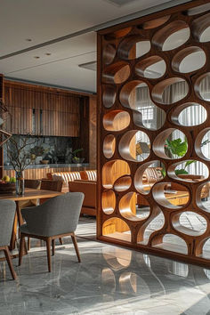 a room divider in the middle of a living area with chairs and tables around it