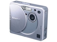 a silver digital camera sitting on top of a white surface