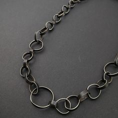 "This was an exercise on repetition, volume and forming just using my hands. It measures 24\" and comes without a clasp. It is made from alpaca or \"nickel\" silver, once it has been oxidized for contrast, brushed in light streaks and waxed the result is a matte dark surface which will not change color with wear. This is quite the statement piece and needs little else if you are one to wear strong pieces of jewelry this one is for you. Ready to ship and packed in a ready for gift giving in a eco Light Streaks, Handmade Chain, An Exercise, Wide Band Rings, Nickel Silver, Delicate Jewelry, Small Rings, Long Black, Cultured Pearls