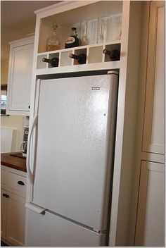 a white refrigerator freezer sitting inside of a kitchen