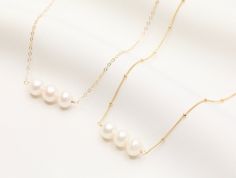 Pearl Chocker Necklace / Pearl Necklace / Simple Gold Choker Necklace / Layering Necklace / Bridesmaid Necklace / 14k Gold Filled - Pendant: 8-9 mm genuine fresh water pearl - 3 pearls charm Please note: since our fresh water pearls are all natural, each pearl is individually unique in size, shape, and shade. We try our best to be consistent as possible to give you the best quality. AVAILABLE LENGTH + 13 inches + 1.5 extension Gold Filled + 14 inches + 1.5 extension Gold Filled + 15 inches + 1.5 Gold Single Strand Charm Necklace As Gift, Single Strand 14k Gold Necklace For Gift, 14k Gold Single Strand Necklace For Gift, 14k Yellow Gold Necklace For Bridesmaid, 14k Yellow Gold Necklaces For Bridesmaid Gift, Minimalist Gold Choker With Pearl Drop, Simple Gold Choker Necklace, Adjustable Gold Choker With Pearl Drop, Minimalist Gold-plated Pearl Necklace With Adjustable Chain