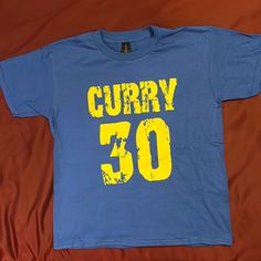 Never Been Worn Curry T-Shirt 100% Cotton Smoke And Pet Free Home Please Allow For Slight Color Variations Due To Lightening Conditions And Screen Settings. All Photos Are My Own. The Item Shown, Is The One You’ll Receive. Kids Shirts, Blue Yellow, Color Variations, Shirts Tops, Colorful Shirts, The One, Top Brands, Kids Shop, Color Blue