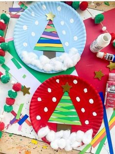 paper plates and craft supplies are arranged on a table with christmas decorations, such as a paper plate tree