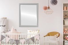 a baby's room with pink and white decor