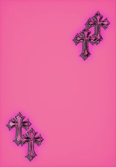 two metal crosses on a pink background