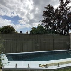 an empty swimming pool in the middle of a backyard