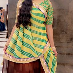 Its Very Elegant Brown Chaniya With Heavy Border With Combination Of Gold And Green Lehariya Dupatta Is Very Georgette Material With Border Blouse Is Green With Cold Shoulder Cut!! Current Blouse Size Is 35 But Can Go Up To 38 ( Need Alterations) But Has Margin To Do So! Chaniya Waist Is 30-32 Most Chaniya Length Is Not Too Long !! I Am 5'6 Tall And It Was Right Below My Ankle ( Just To Give You An Idea) Its Over All Beautiful Elegant Looking Choli With Rare Combination. Green Combination Color, Lehariya Dupatta, Green Combination, Combination Color, Georgette Material, Brown And Green, Gold And Green, Chaniya Choli, Shoulder Cut