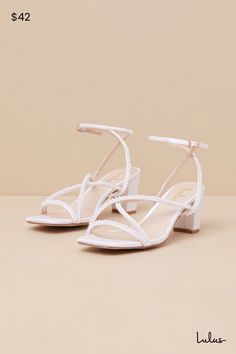 From cute date nights to wedding invites, step out with confidence in the Lulus Makenna White Pearl Satin Strappy Ankle Strap Low Heel Sandals! These wear-with-anything sandals have a sleek woven satin construction that shapes a trendy square footbed with a slender toe strap and crisscrossing vamp straps. An adjustable ankle strap sprouts from the sides and secures with a shiny gold buckle, all atop a cute block heel. Gleaming faux pearl details throughout lend an extra fabulous finish. 2. 5" wr White Heels Short, Shoes Hoco, Hoco Inspo, Bridal Shoes Low Heel, Cute Date, Trendy Heels, Sparkly Shoes, Pearl Details, Greek Wedding