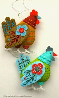 two colorful handmade ornaments hanging from strings