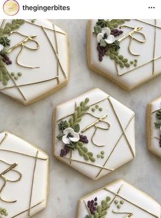 cookies decorated with icing and flowers are arranged in the shape of hexagons