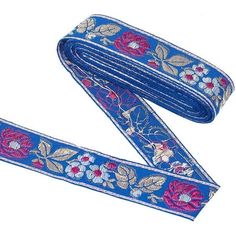 a blue ribbon with flowers and leaves is shown on a white background, it has a pink flower in the center