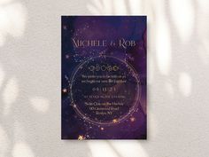 a purple and gold wedding card on a white wall