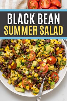 black bean and corn salad in a white bowl with a spoon on the side, surrounded by tomatoes