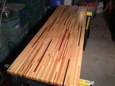 a large wooden table sitting inside of a garage