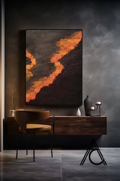 an abstract painting hangs on the wall next to a chair and table with vases