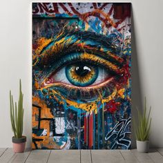 an eye painted on the side of a wall next to potted plants and cacti