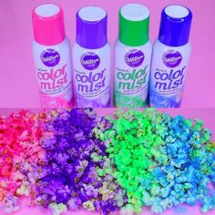 four spray bottles filled with different colored confetti