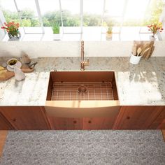 a kitchen sink sitting on top of a counter next to a wooden cabinet and window