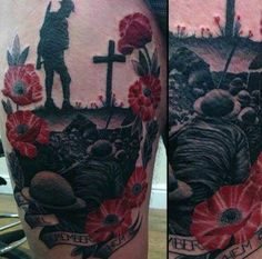 a man with tattoos on his arm and leg is standing in front of a cross